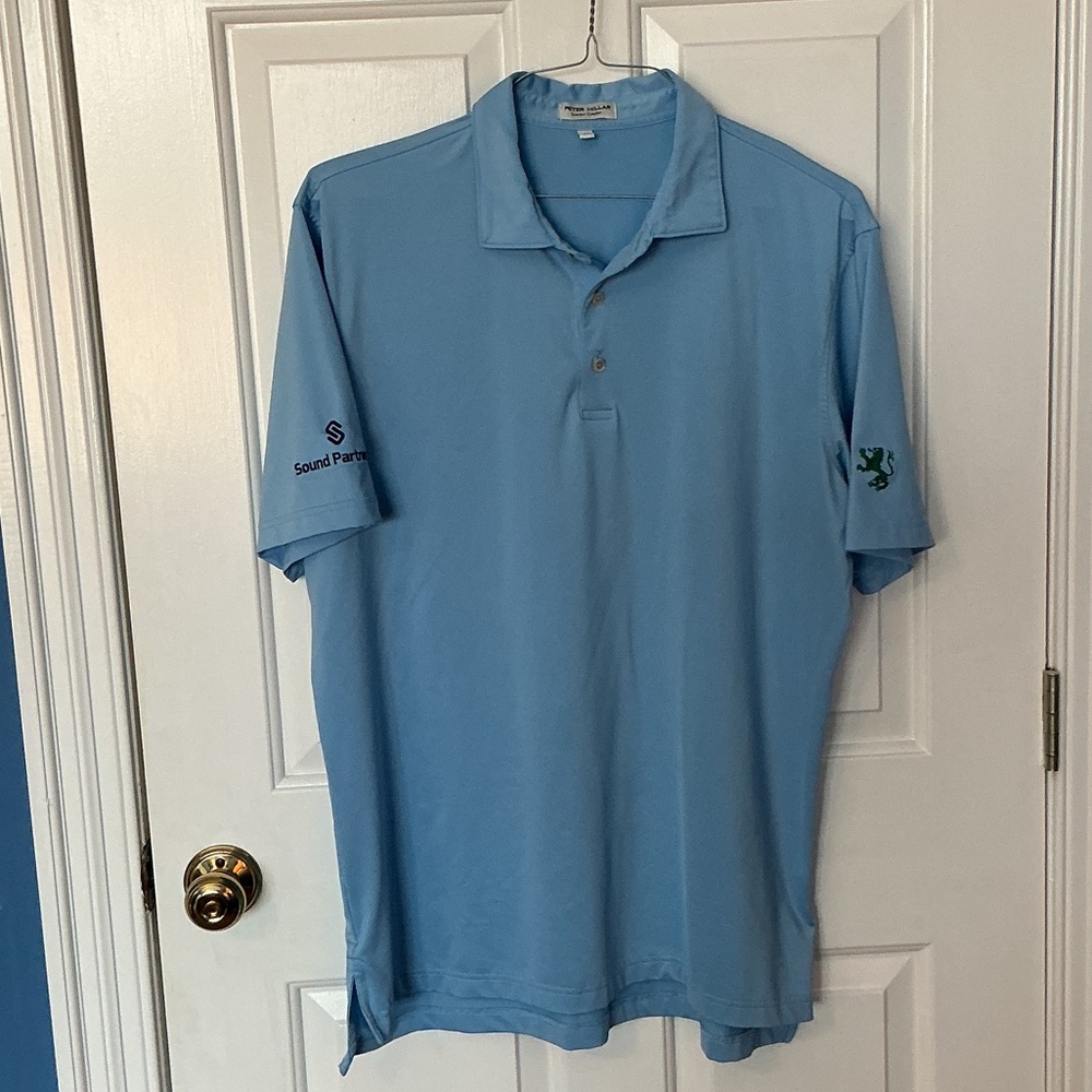 Peter Millar men’s blue golf shirt with sleeve insignias.  Large